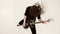 Stylish solo guitarist with dreadlocks on his head and in black clothes on a white background expressively playing the