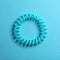 Stylish spiral rubber band on background, top view