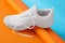 Stylish sportive shoe with white lace on color background