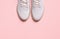 Stylish sporty sneakers on pink background, top view. Space for text