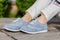 Stylish Steps: Fashionable Woman\\\'s Legs in Blue Sneakers at the Park