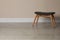 Stylish stool near beige wall indoors. Space for text