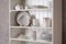 Stylish storage stand with different ceramic dishware