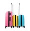 Stylish suitcases packed for travel on white background.