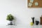 Stylish table Board and post it, book, pencil, glasses  and coffee mug with tablet on table with wall.