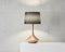 Stylish table lamp mockup with black shade and gold stand on white table