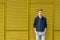 Stylish teen boy over industrial yellow background