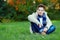 Stylish teenage boy on green grass