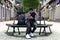 Stylish teenager on a city street sitting on a bench