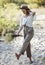 Stylish teenager girl walks barefoot in the sand