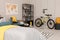 Stylish teenager`s room interior with comfortable bed and sports equipment