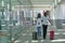 Stylish tourist black couple with suitcases walking along street near by the station and talking