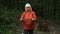 Stylish traveler active senior 50s woman with Irish Setter dog looking at mountains, exploring woods. Travelers explore