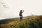 Stylish traveler girl holding hat with backpack and windy hair i