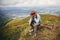 Stylish traveler man sitting on top of mountains in clouds. spa