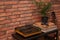 Stylish turntable and vinyl records on shelving unit near red brick wall