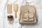 Stylish urban backpack and different items on white fabric, flat lay