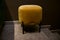 Stylish velour yellow footstool, ottoman in the furniture design studio