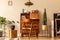 Stylish and vintage interior design of open space with retro furniture, plants and decoration.