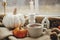 Stylish warm cup of tea, candle, pumpkins on cozy wool blanket against window with rain drops. Moody fall wallpaper. Happy