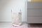 Stylish white laundry basket standing in modern room, Modern retro Scandinavian decoration. New Home interior