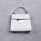 Stylish white leather women\\\'s handbag with a top handle, a black trim, a silver metal accent