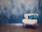 Stylish white soft and fluffy chair on the background of the textured wall of blue shade