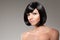 Stylish woman with a bob hairstyle. Girl model with a short black fringe and vlosami.