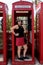 Stylish Woman in Classic Red British Telephone Box