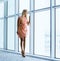 Stylish woman near the window in the office building