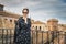 Stylish woman posing in the old part of the town against tile roofs. Medieval city of Toledo in the center of Spain.