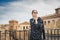 Stylish woman posing in the old part of the town against tile roofs. Medieval city of Toledo in the center of Spain.