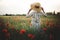 Stylish woman in rustic linen dress walking in summer meadow among poppy and wildflowers in sunset light. Atmospheric authentic