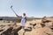 A stylish woman takes a selfie in the crater of the Teide volcano. Desert landscape in Tenerife. Teide National Park. Desert