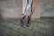 Stylish woman in a woolen coat, white cashmere scarf and brown boots