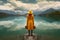 Stylish Woman in Yellow Jacket Admiring Autumn Lake and Mountain Panorama. Generative Ai