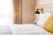 Stylish wooden, black color bedside lamp, wooden bed and grey blanket in bedroom. Comfortable and elegant interior design.