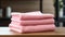 Stylish Wooden Table With Stacked Pink Towels