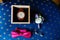 Stylish wristwatch in a wooden box. Pink bow tie, beautiful glass cufflinks, flower boutonniere. A men\'s set of accessories on an