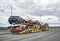 Stylish yellow big rig car hauler semi truck with same color modular semi trailer transporting cars moving on the wide multiline