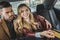 stylish young couple sitting together in taxi girl