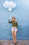 Stylish young female with sunglasses holding balloons