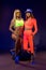 Stylish young fit sportswomen standing in bright studio with bosu ball