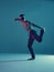 Stylish young guy breakdancer dance hip-hop without shirt in neon blue light. Dance school poster