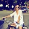 Stylish young hipster woman on a retro bicycle. Outdoor fashion