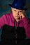 Stylish young man in a blue hat and a lilac sweatshirt. Youth of the future. Studio photography