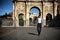 Stylish young man in front of Arco di Costantino, Rome, Italy