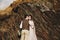 Stylish young wedding couple has fun posing in beautiful Georgian mountains