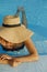 Stylish young woman in hat relaxing in blue pool and enjoying summer holiday. Summer tropical vacation. Girl in sunhat on vacation