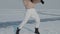 Stylish young woman, professional dancer, dancing energetic jazz funk or hip hop on frozen lake in cold winter. Female